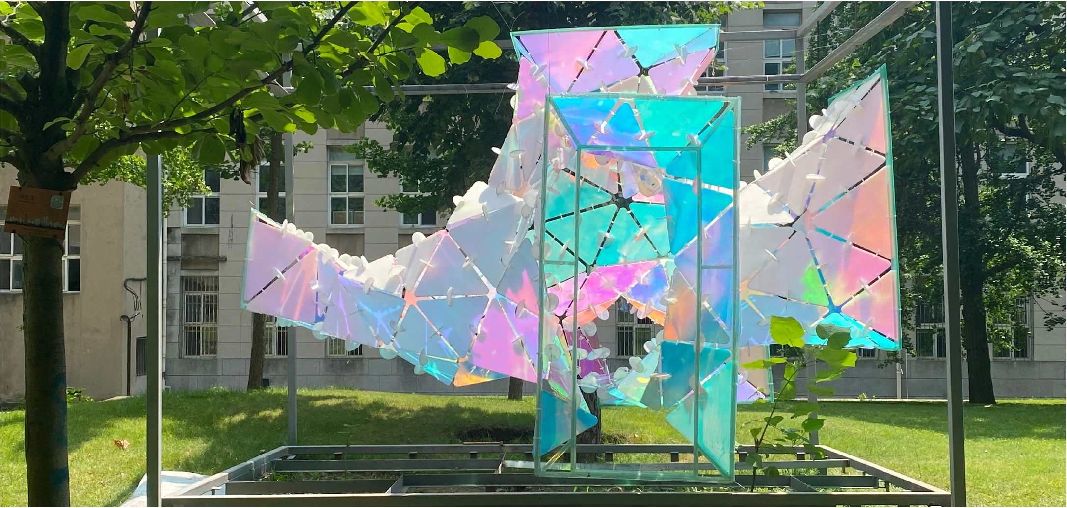 Built outdoor installation assembled from iridescent reflective panels in a lightweight frame
